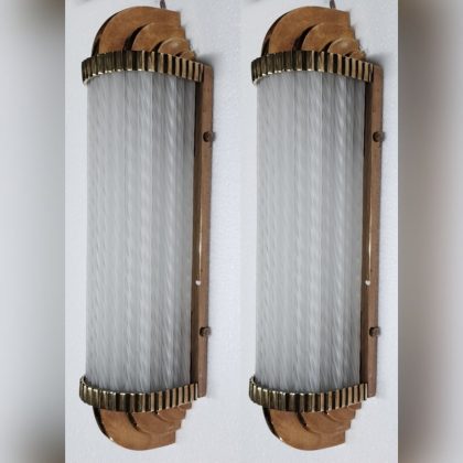 A pair of vintage Art Deco skyscraper-style wall sconces made from brass and frosted ribbed glass rods, measuring 17 inches in length, 4 inches in breadth, and 4 inches in width.