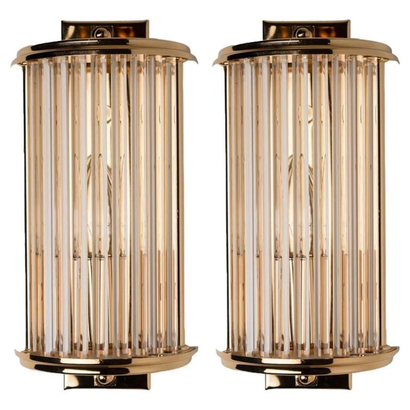 A pair of vintage Art Deco skyscraper-style wall sconces made of brass with glass rods, measuring 15 inches in length and 5 inches in breadth.