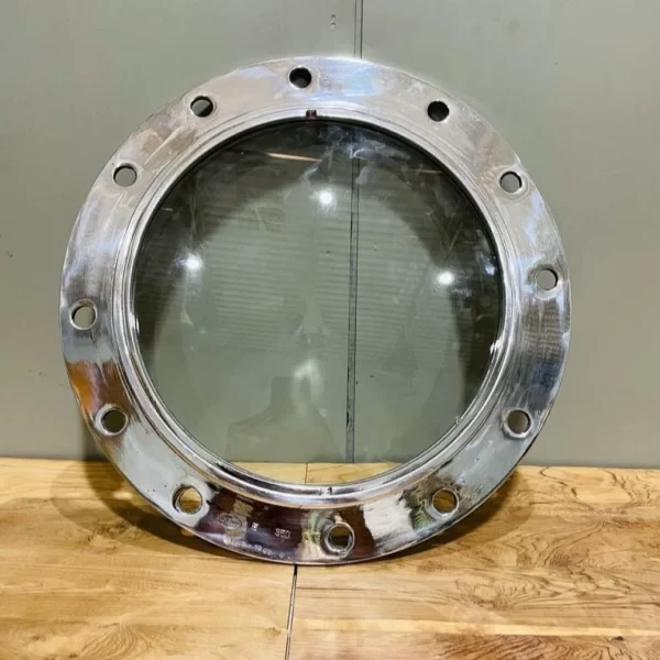 Authentic nautical style! This 14” aluminum ship porthole with clear thick glass is perfect for coastal homes, bars, or industrial decor lovers.