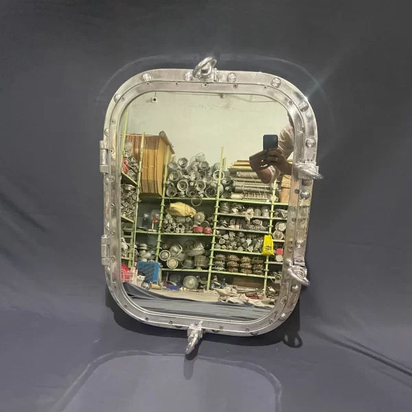Rectangular ship porthole mirror with polished aluminum frame, 18x24 inch glass, hinges, and locking latches for nautical wall décor.