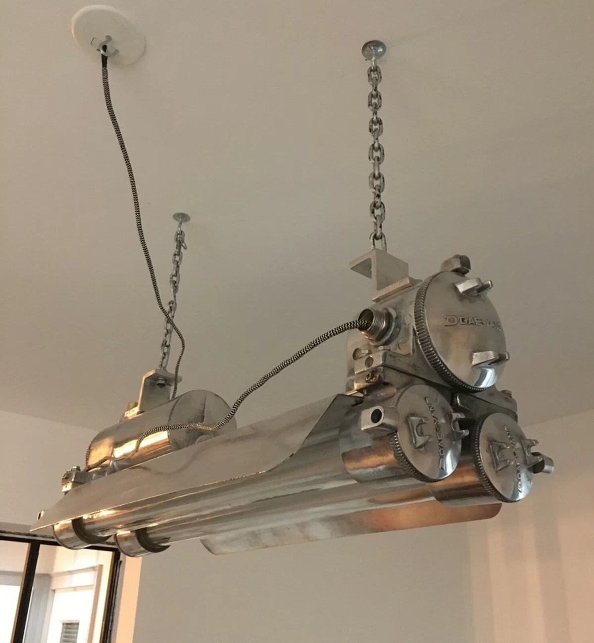 Vintage polished Daeyang flameproof strip light from 1978, restored explosion proof industrial pendant lamp with aluminum body, brass fittings, and dual LED tubes.